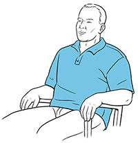 Man sitting in chair doing pursed-lip breathing.